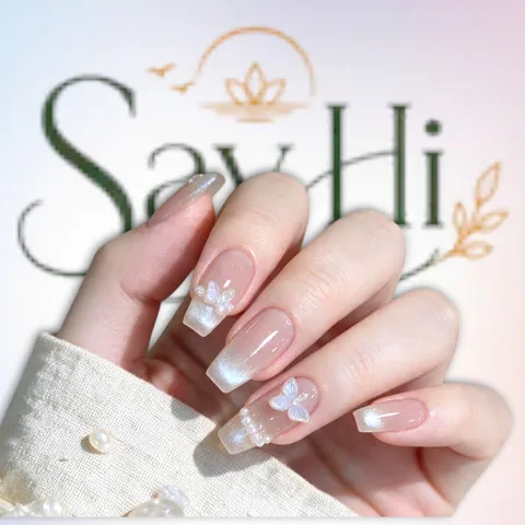 nude nails with white butterfly and pearls – Say Hi Spa Hanoi